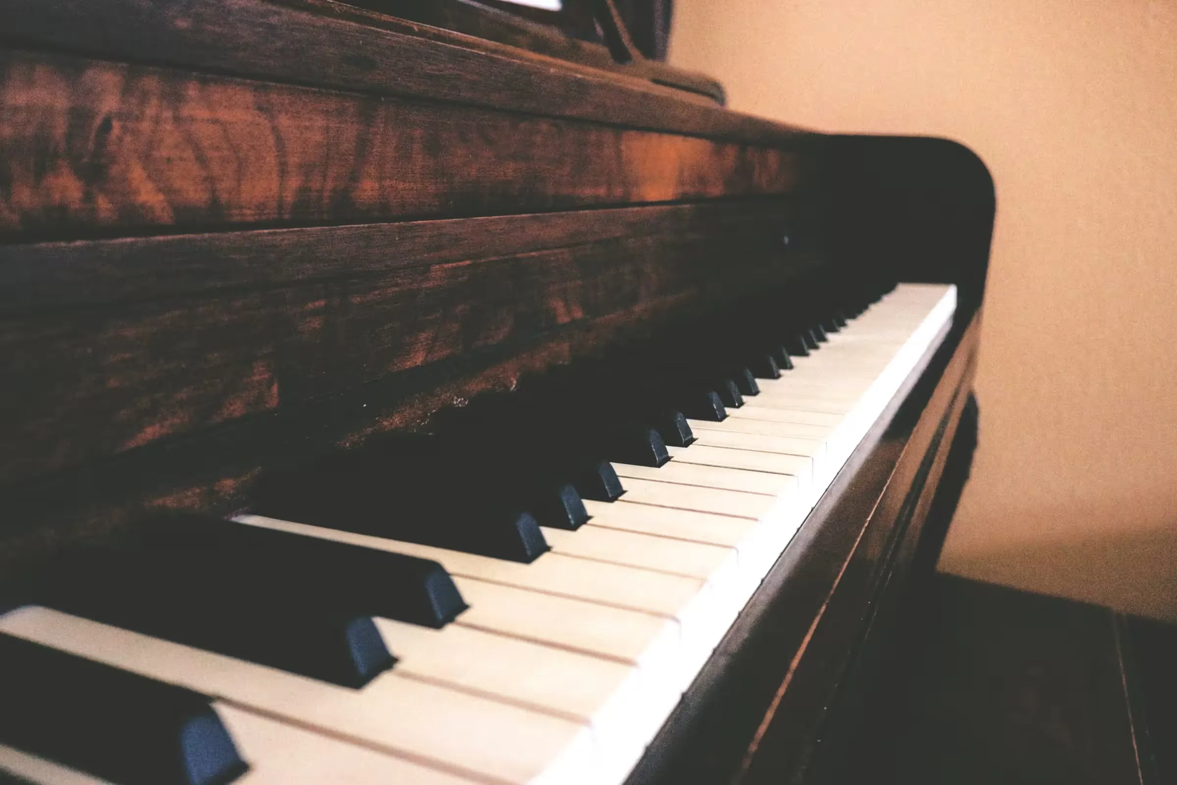 The keyboard of a dark wood upright piano